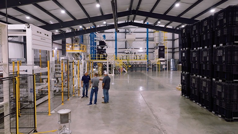 People talking in Richardson Seeds plant